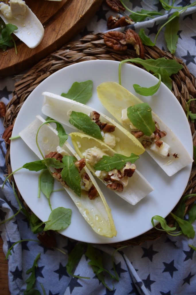 Pecan and Goat Cheese Endive cups on a plate