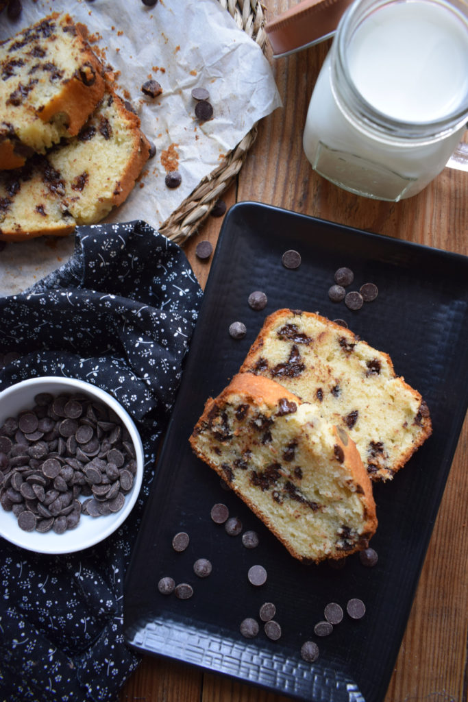 slices of a chocolate chip loaf cake with a glass of milk