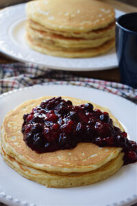 a stack of pancakes with berries on the top