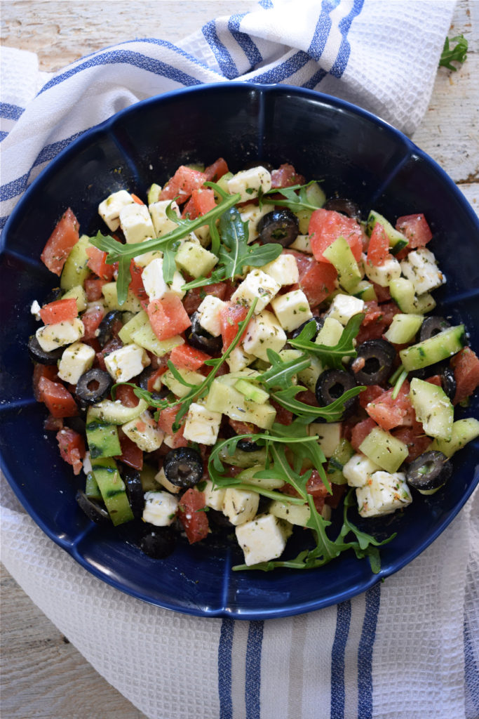 Greek Style Salad in a blue bowl