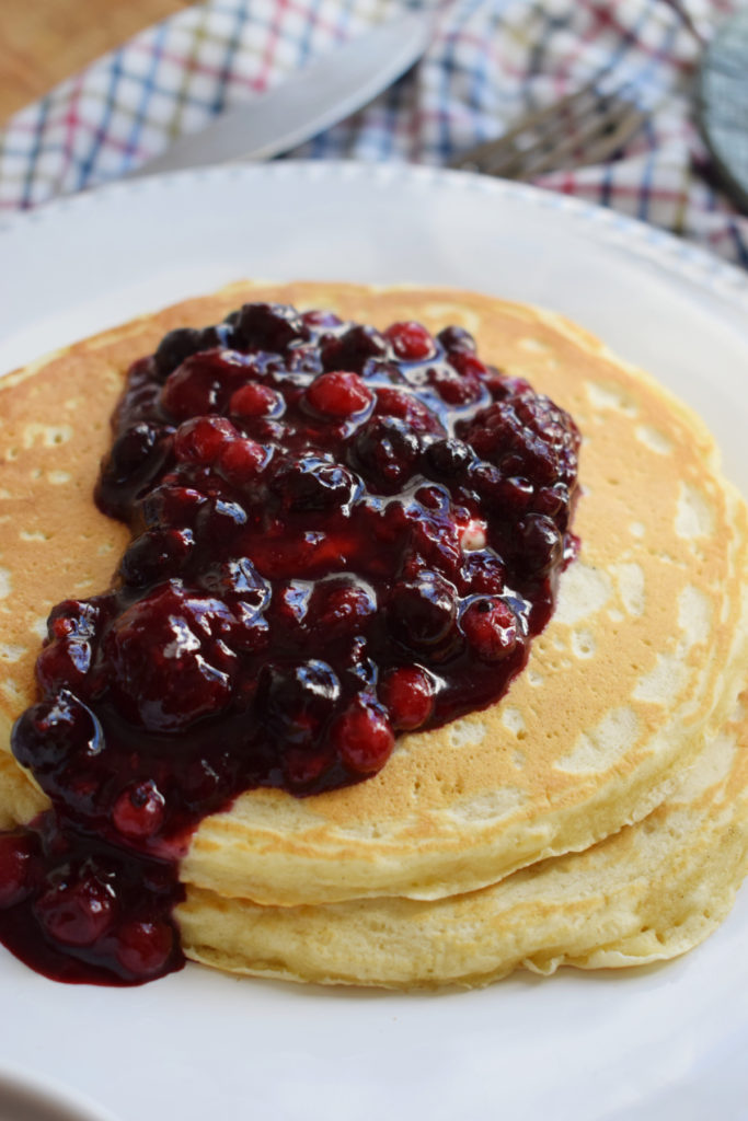 close up of pancakes with a berry topping