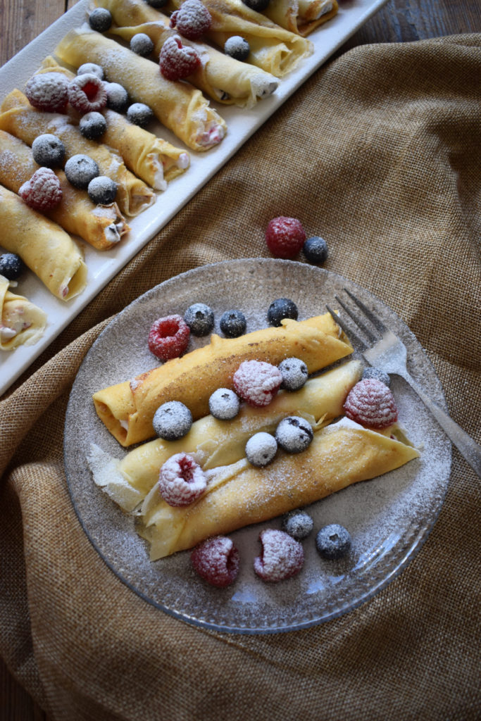 crepes on a plate with berreis 