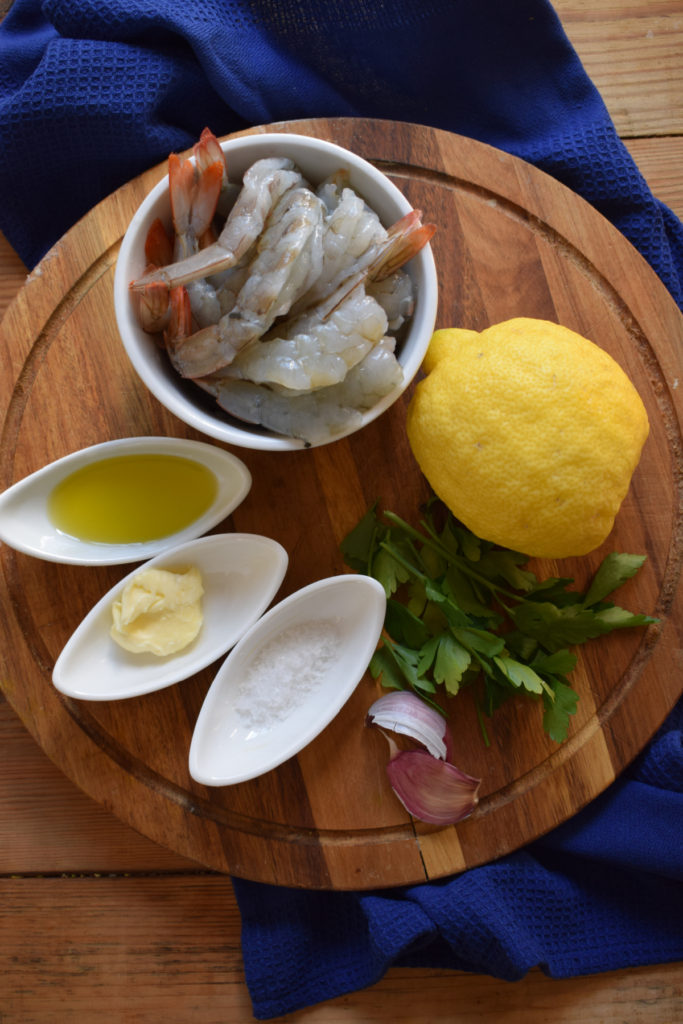 Ingredients to make zesty lemon shrimp in a skillet.