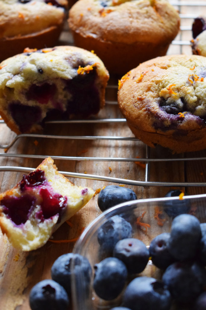 Fresh blueberries with blueberry and orange muffins.