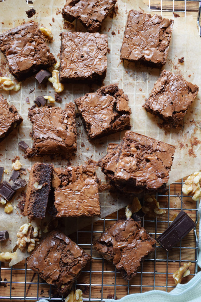 Chocolate brownies on parchment paper.
