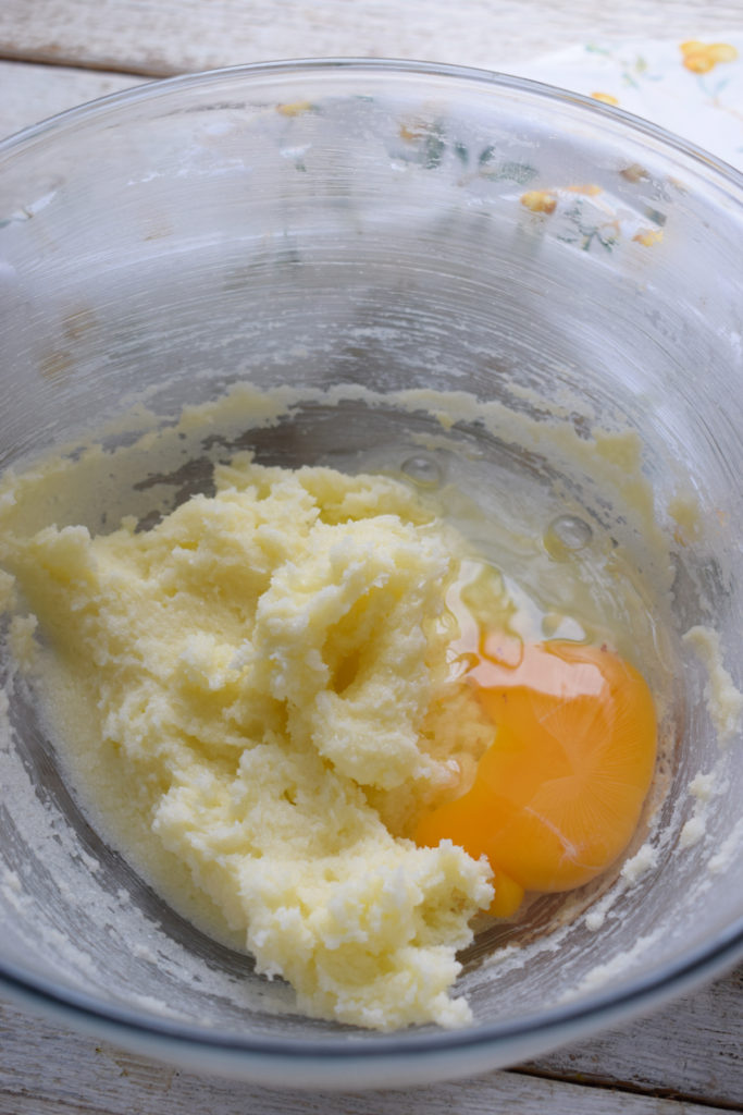 adding eggs to butter and sugar.