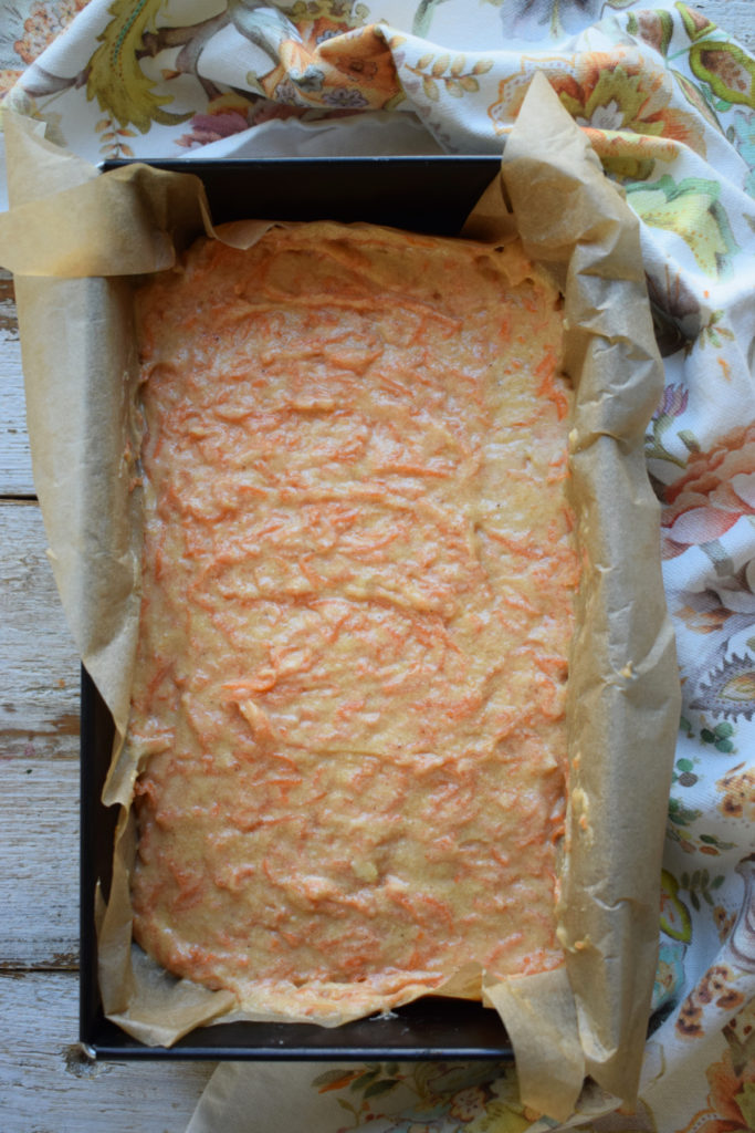 Carrot cake in a loaf tin ready to bake.