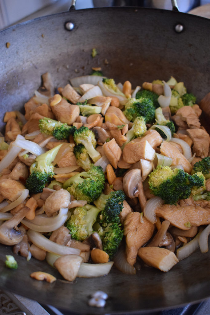 Chicken and vegetable stir fry in a wok.