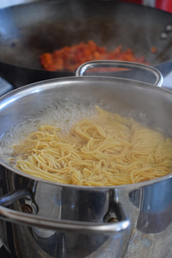 Noodles cooking in boiling water.