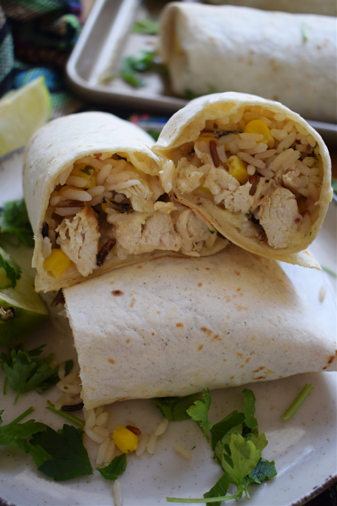 Close up of Mexican Chicken and Rice Wraps cut in half.