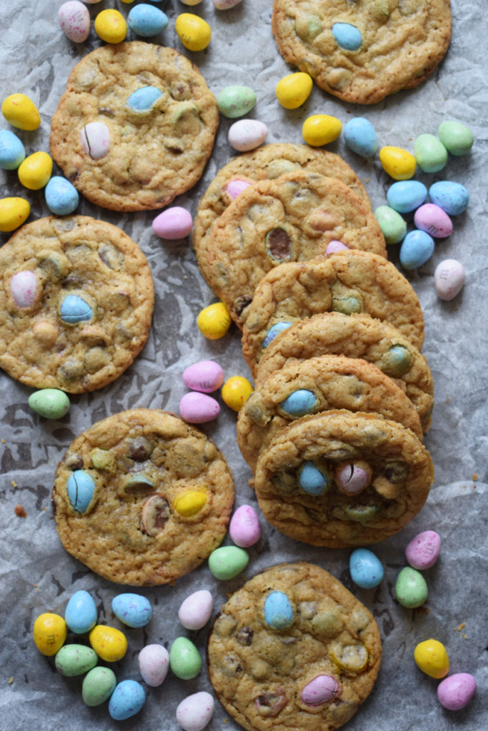 Mini egg cookies on a baking tray with mini eggs.