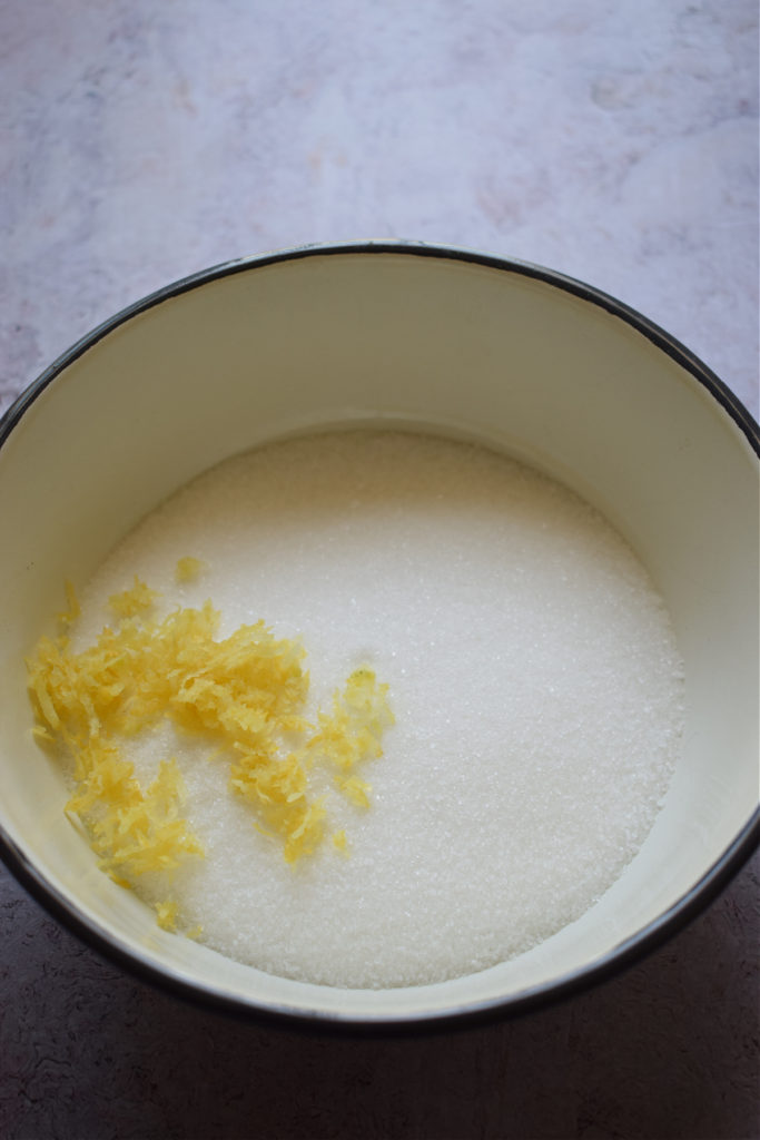 Adding lemon zest to sugar.