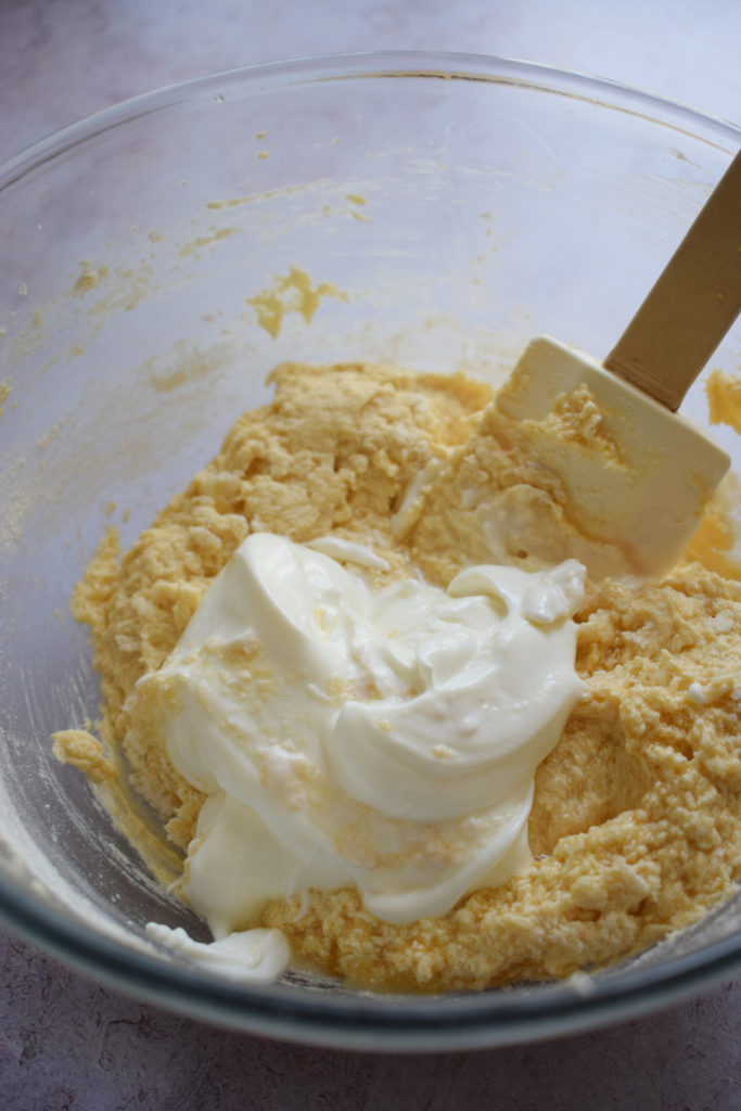 Adding sour cream to batter.