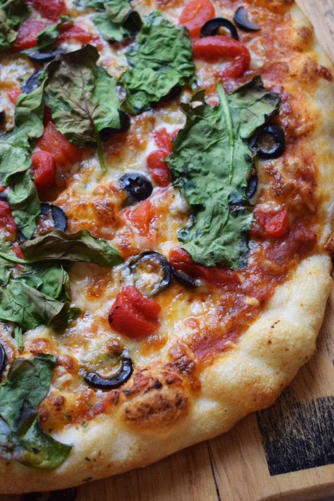 Close up of a mediterranean pizza.