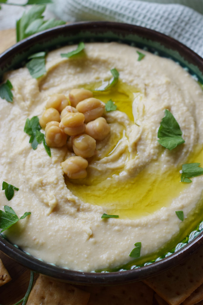 Hummus in a serving dish with olive oil