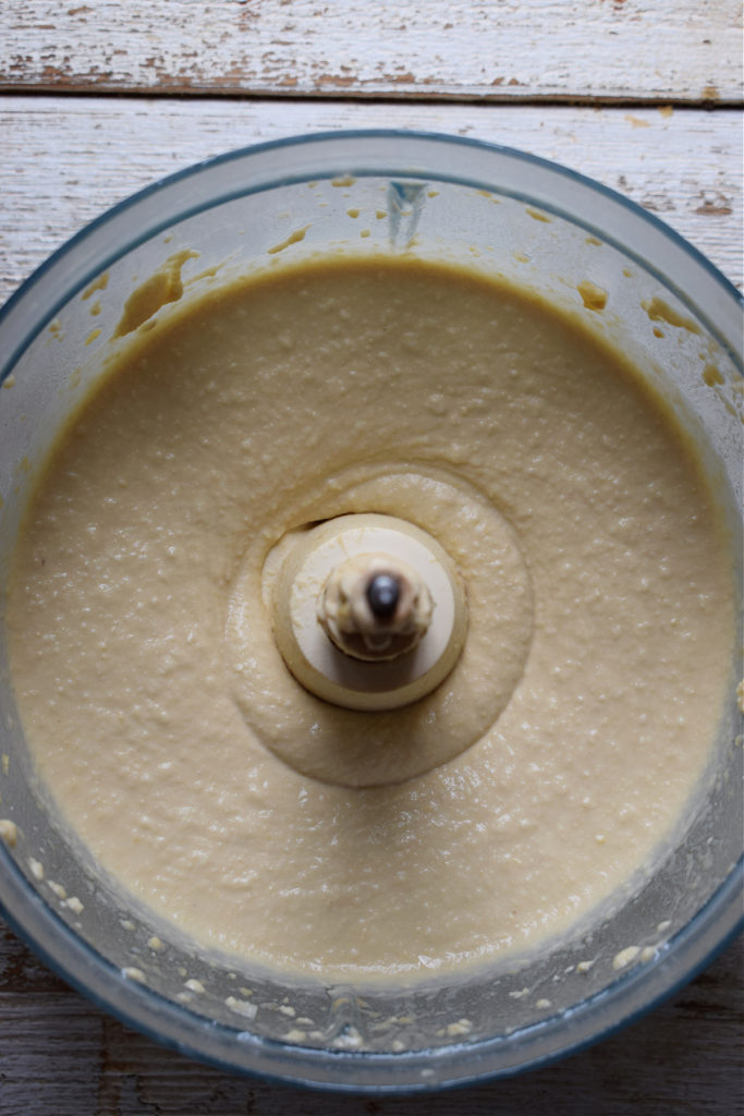 Blended homemade hummus in a food processor.