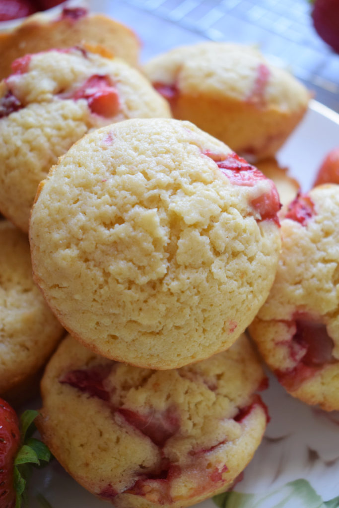 Close up of strawberry and lemon muffins on a plate.
