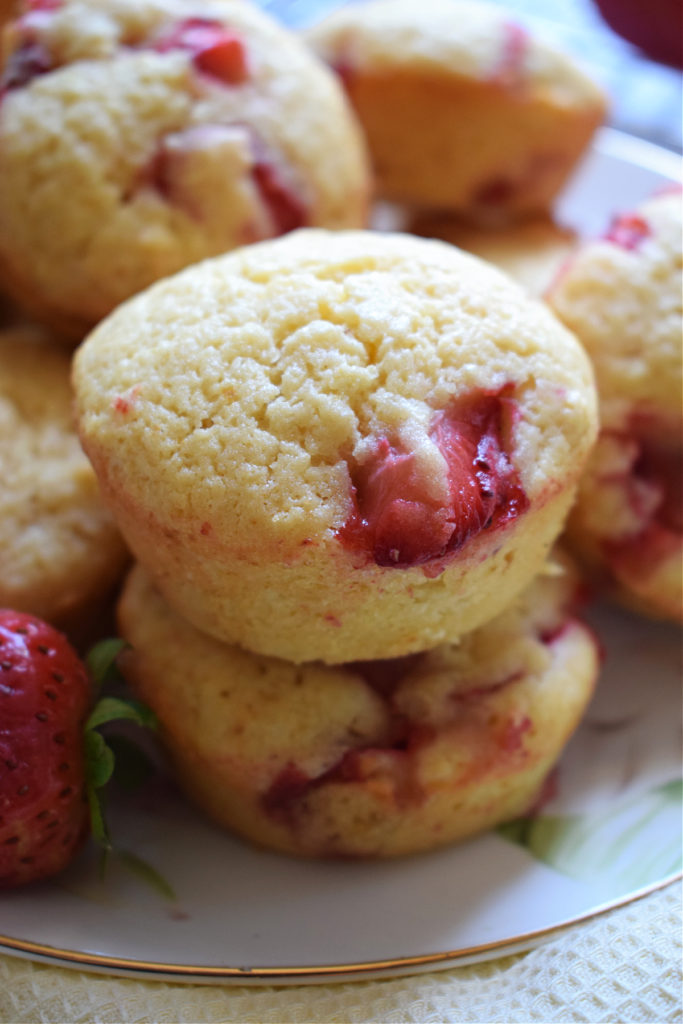 Lemon and strawberry muffins stacked.