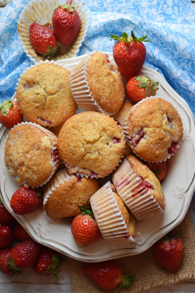 Strawberry Shortcake muffins in a bowl with a blue tea towel.