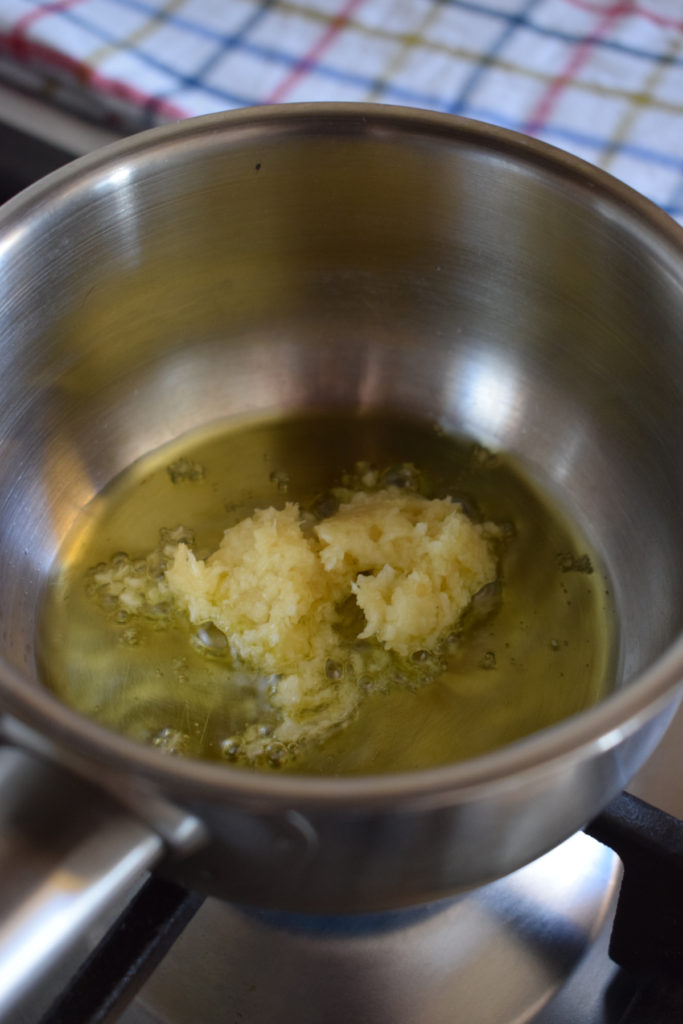 Olive oil and garlic in a saucepan.