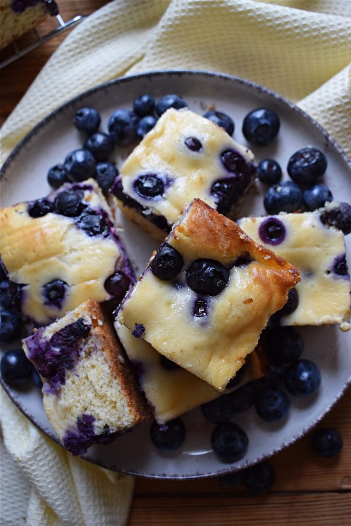 Blueberry cake squares on a plate.