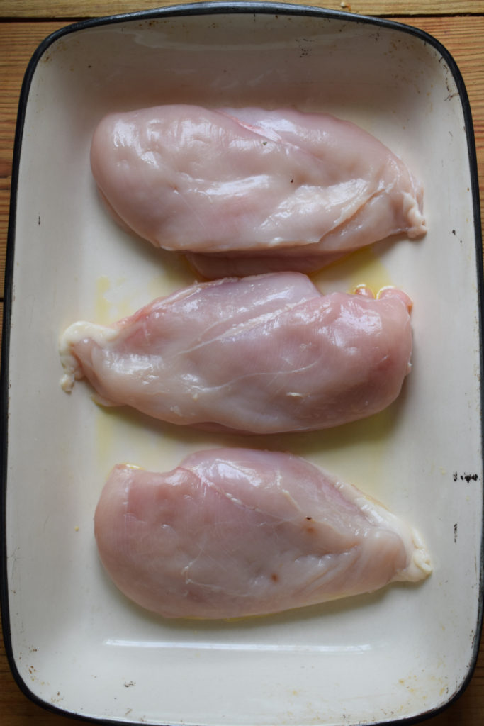 Chicken breast in a baking dish.