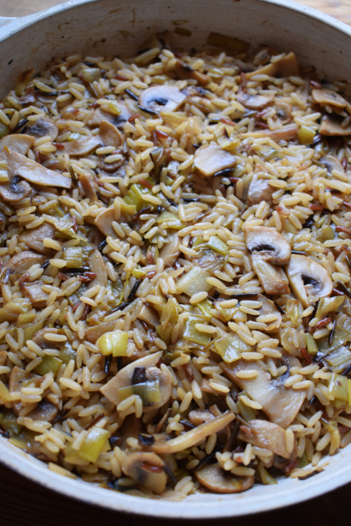 Cooked mushroom and leek wild rice in a skillet.