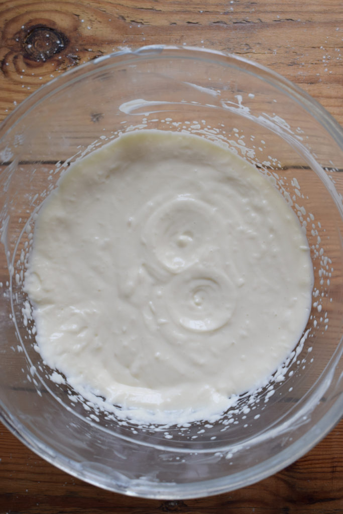 Mixed cream cheese mixture in a glass bowl.