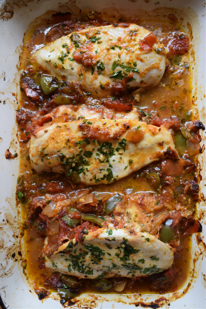 Baked stuffed chicken breast in a baking dish.