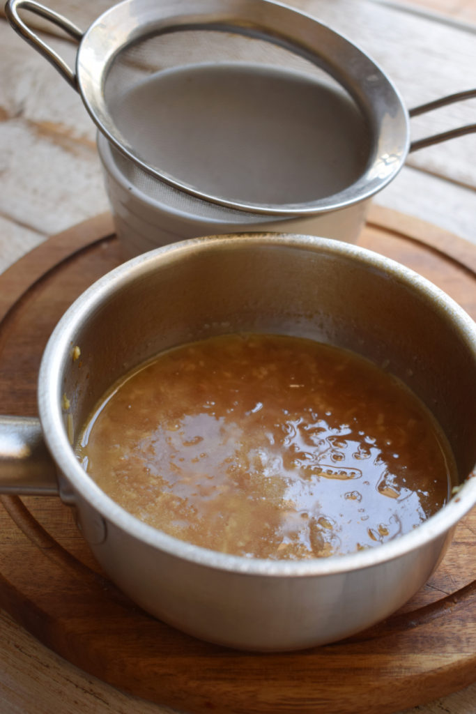 Making a wine sauce in a saucepan.