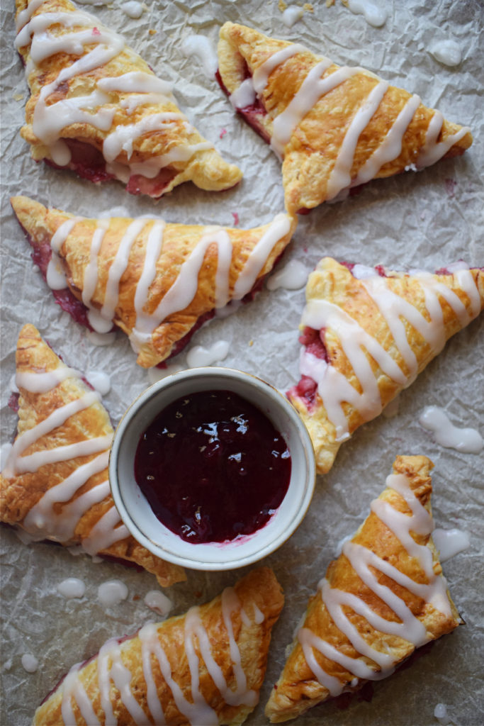 Puff pastry on a baking tray with jam.