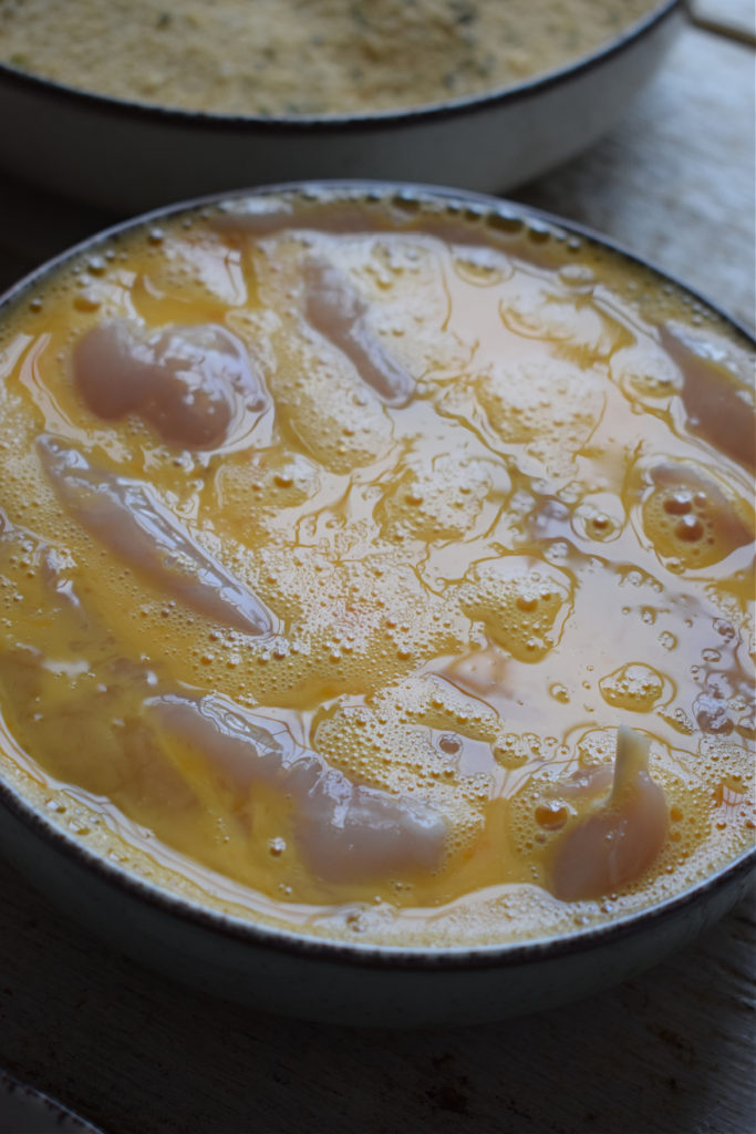 Dipped chicken tenders in eggs.