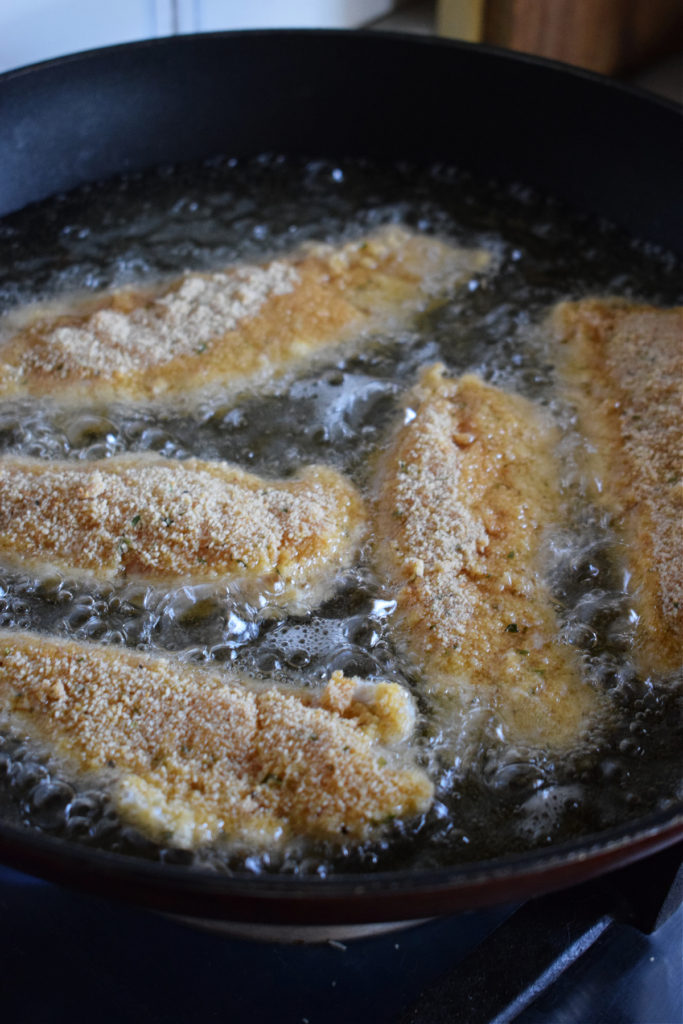 Frying chicken in oil.