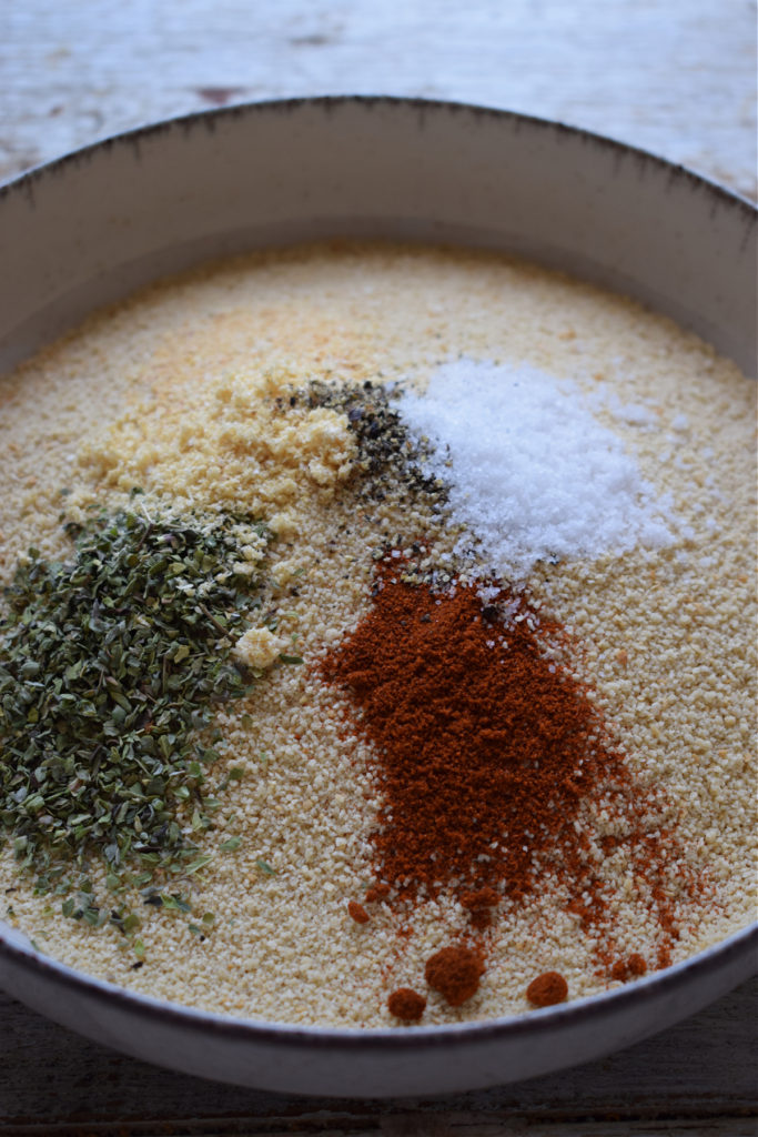 Add seasonings to fine bread crumbs in a bowl.