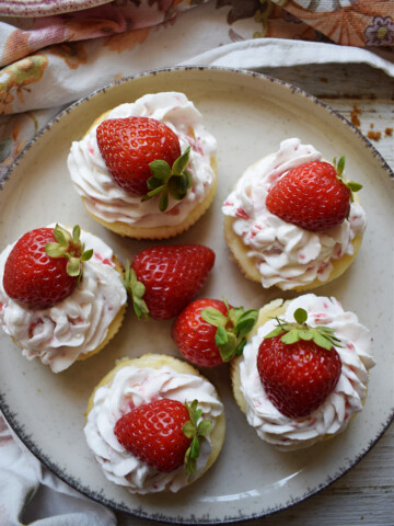 Mini cheesecakes on a plate.