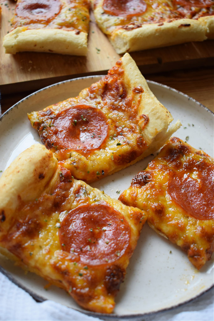 Sheet pan pepperoni pizza bites on a plate.
