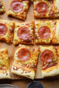 Sheet pan pepperoni pizza bites cut into slices.