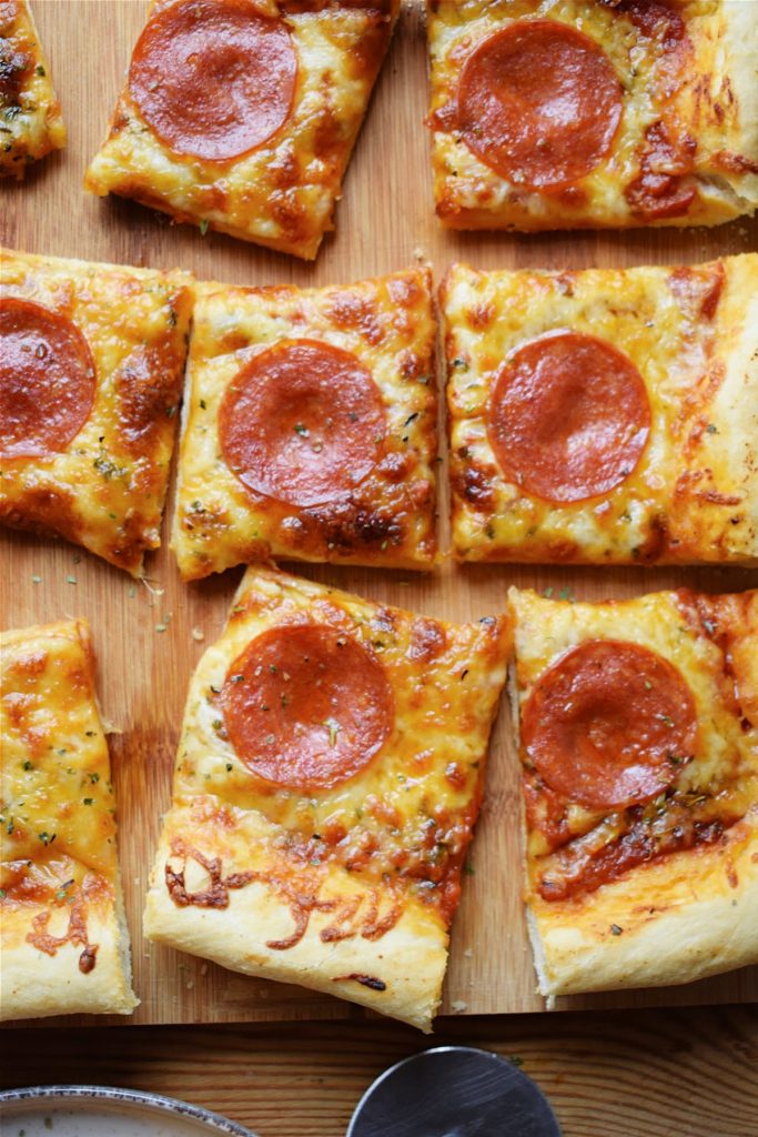 Sheet pan pepperoni pizza bites cut into slices.