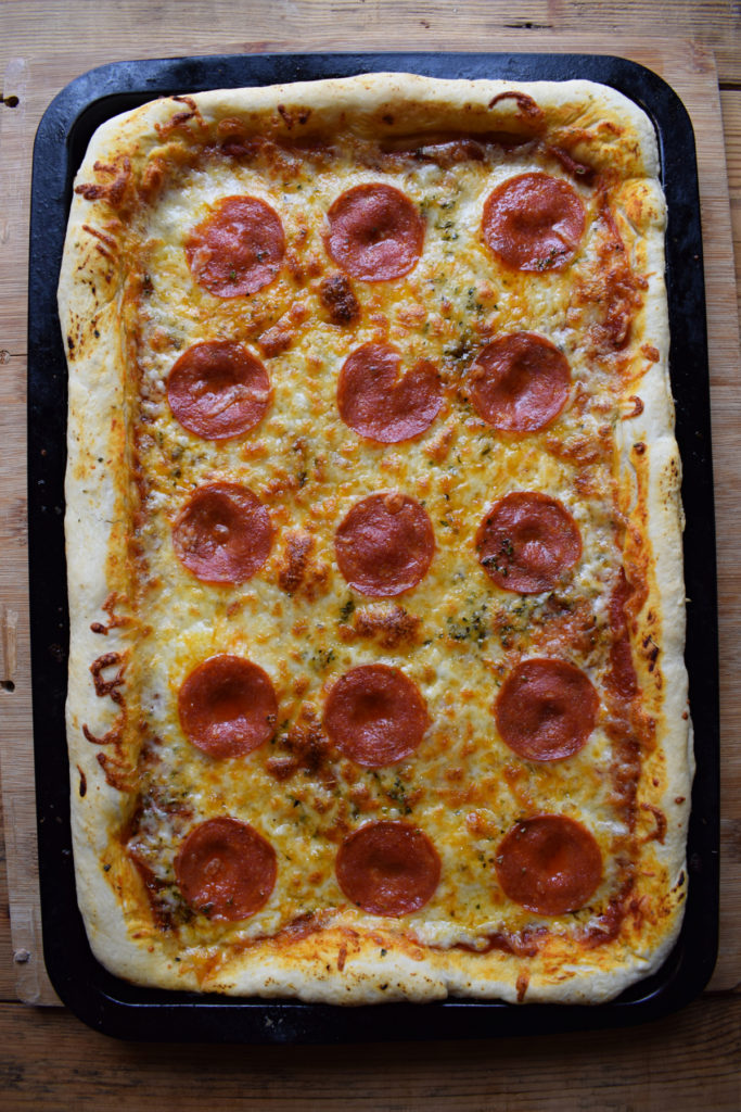 A freshly cooked sheet pan pepperoni pizza.