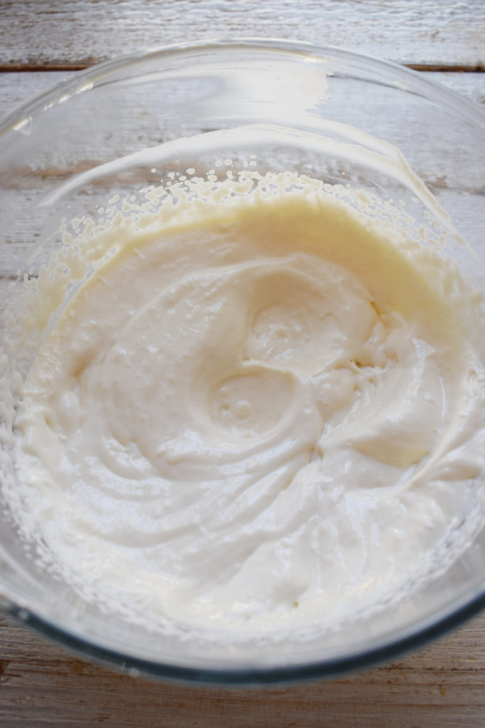 Whipped cream cheese filling in a glass bowl.