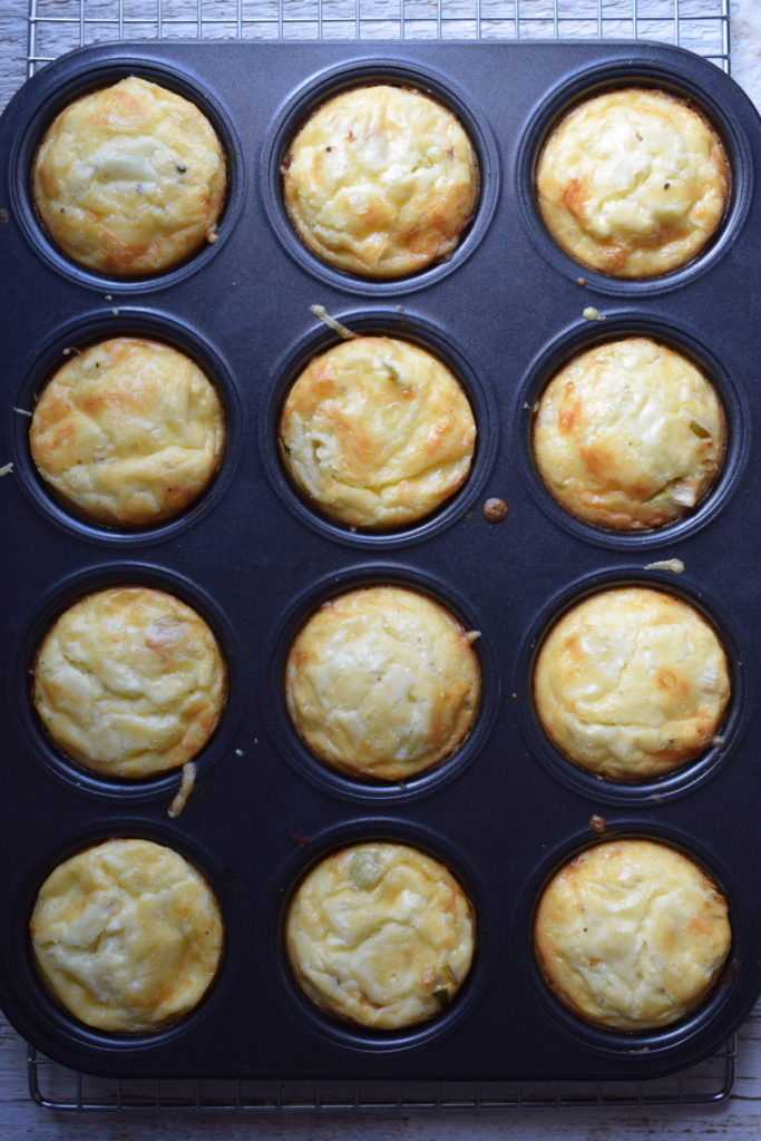 Freshly baked mini quiche in muffin tins.