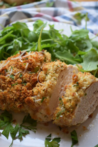 Sliced breaded chicken with salad.