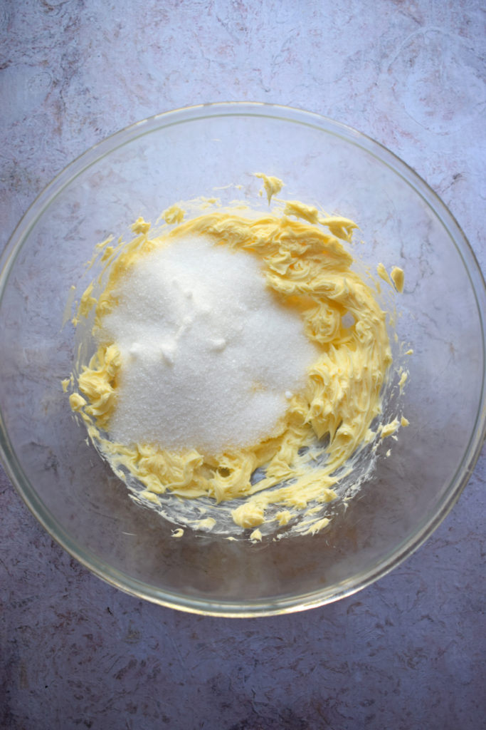 Sugar and butter in a mixing bowl.
