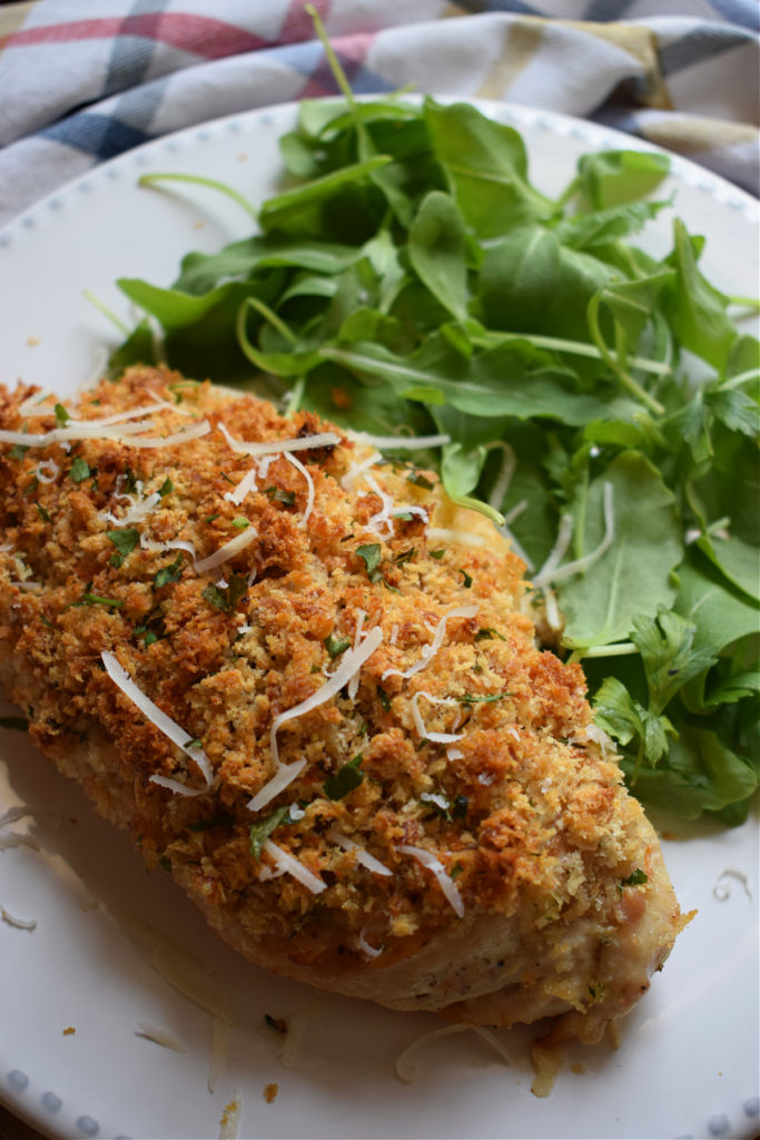 Baked chicken parmesan with a salad.