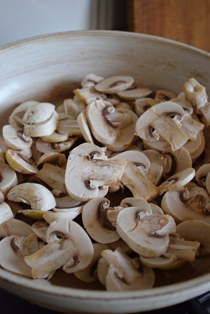 Cooking mushrooms for an Alfredo pizza.