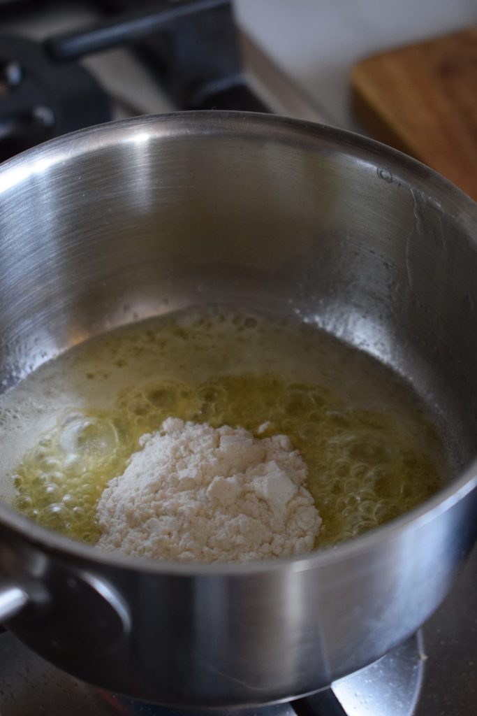 Melting butter and flour to make a roux sauce.