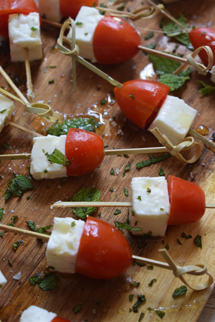 Tomato appetizers on a wooden board.