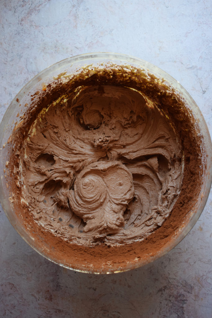 Making chocolate buttercream frosting.