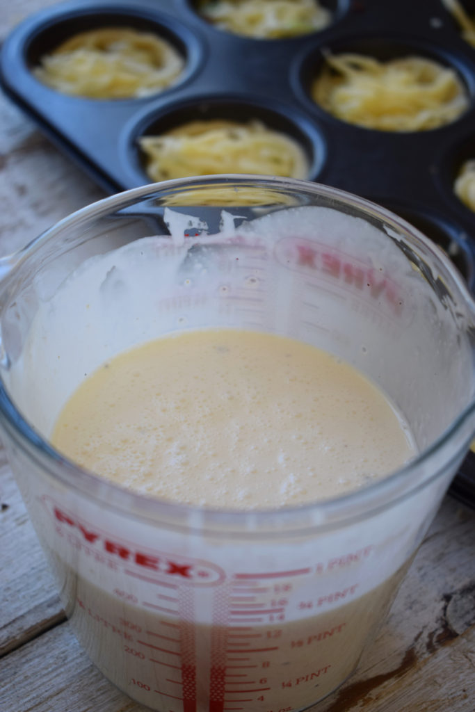 Whisked cream and eggs to make quiche.
