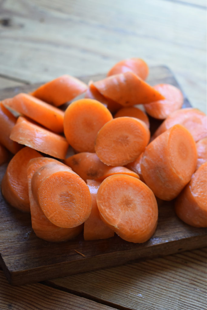Cut carrots on a cutting board.